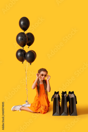 Little girl with balloons a...