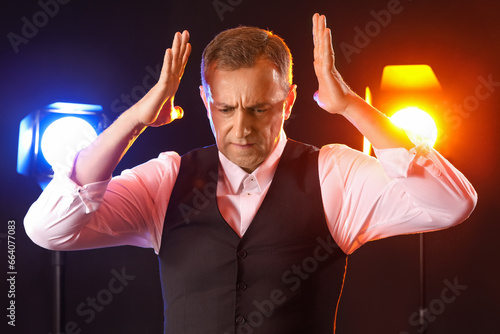 Mature actor on dark backgr...