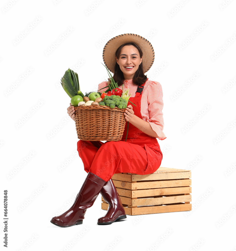 Female farmer with basket of vegetables on white background
