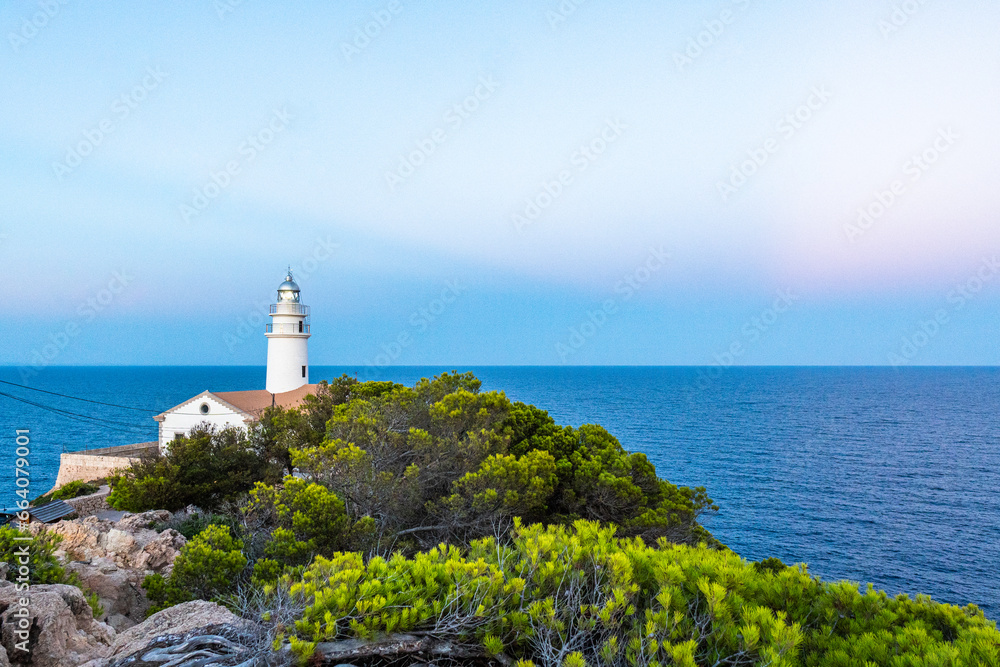 Capdepera Lighthouse at the beautiful coast with the Mediterranean Sea and stunning cliffs of Cala Ratjada on Majorca Island, Spain
