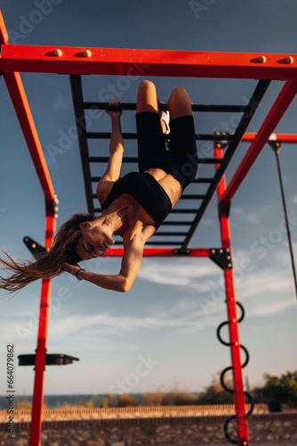 Fitness woman do exercise at the outdoor training gym during sunset