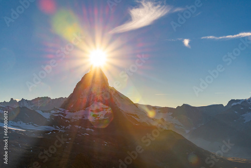 The evening sun appears to caress the summit of the renowned Matterhorn in Zermatt, Switzerland. This awe-inspiring image epitomizes the magic of alpine evenings.