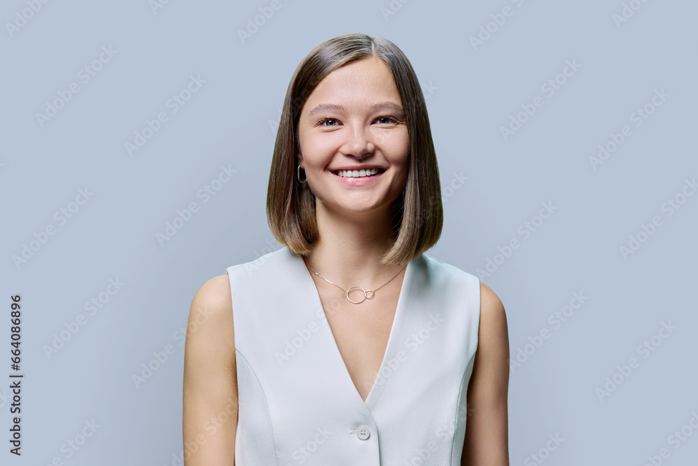 Portrait of young elegant business woman, on gray studio background Portrait of young elegant business woman, on gray studio background