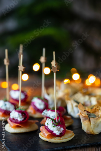 Christmas canapes with blinis with salmon, beetroot and goat cheese and filo pastry cups