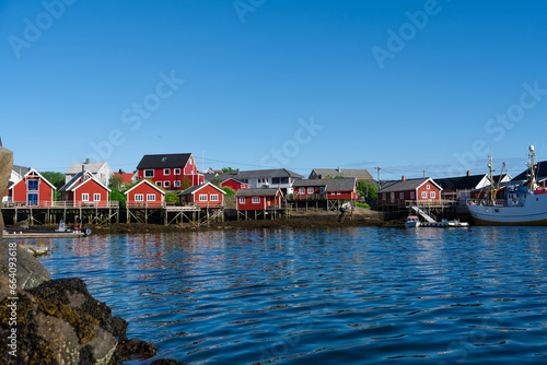 Summer in Reine, Lofoten Islands, Norway. Popular tourist destination. Old fishermans village with wooden red cottages Rorbuer - by Classic Norway Hotels
