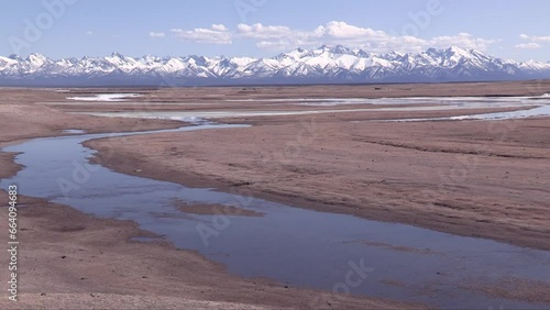 Wide meadows and flowing rivers in autumn. Beautiful scenery of snow-covered snowy mountains in northern Mongolia. Looking at this scenery is healing meditation.