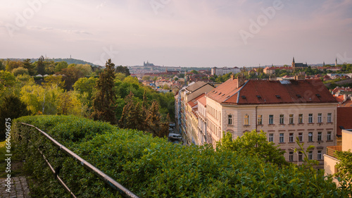 View of Prague Castle from the summer Vyšehrad. Amazing view of the city rooftops with green foreground.