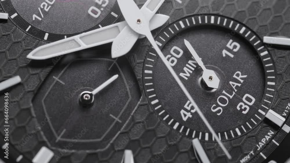 Second arrow running on the black clockface of luxury swiss watch with chronograph. Light flash on the turning clockface. Closeup real time shot. Running second arrow Second arrow running on the black clockface of luxury swiss watch with chronograph. Light flash on the turning clockface. Closeup real time shot. Running second arrow