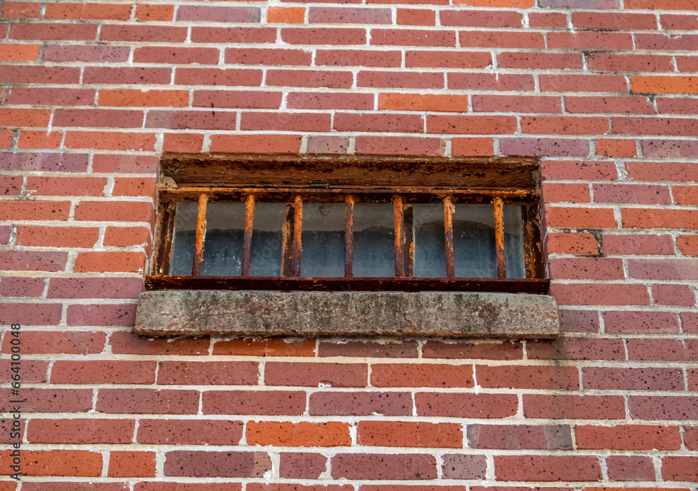 up close view of window with wrought iron bars on old brick building ...