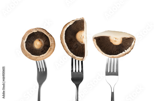 Portobello mushroom, portabella or portobella isolated on forks on white background. Big brown sliced photo