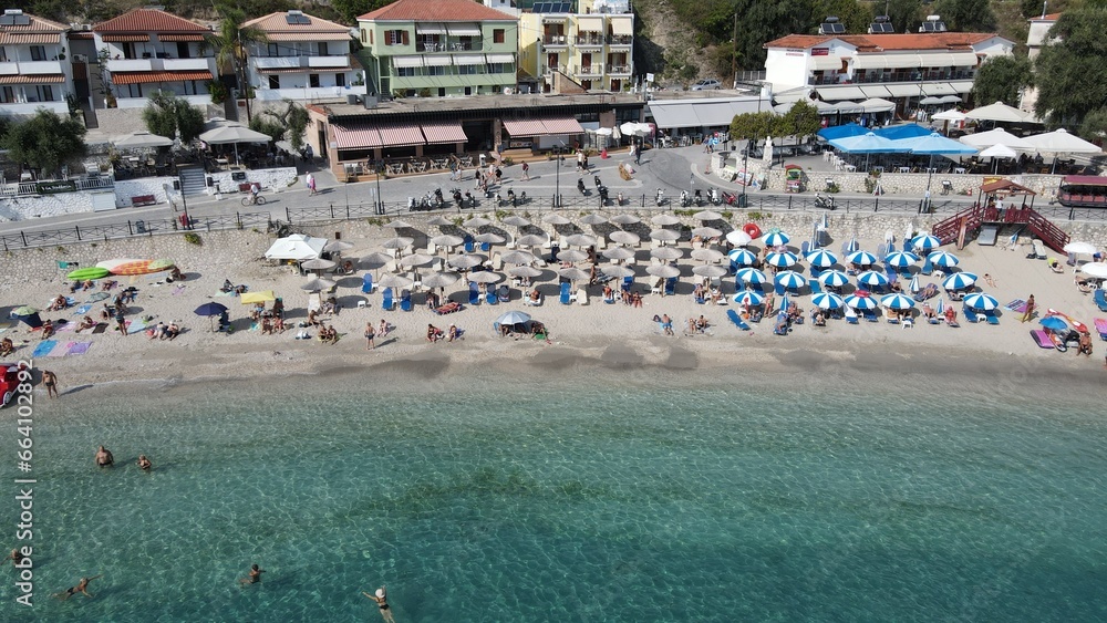 Aerial drone view parga greece, beach crowded with tourists in vacation on summer in famous greek caribbean parga town epirus preveza