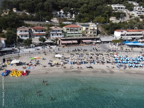 Aerial drone view parga greece, beach crowded with tourists in vacation on summer in famous greek caribbean parga town epirus preveza photo