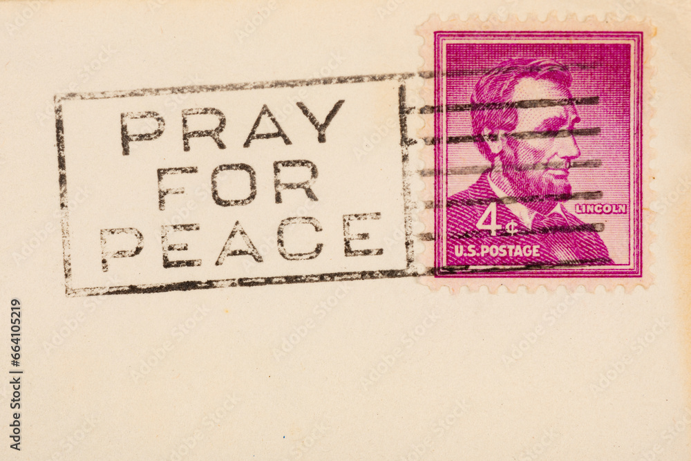 Pray for peace postmark cancellation stamp on an aged postcard with copy space