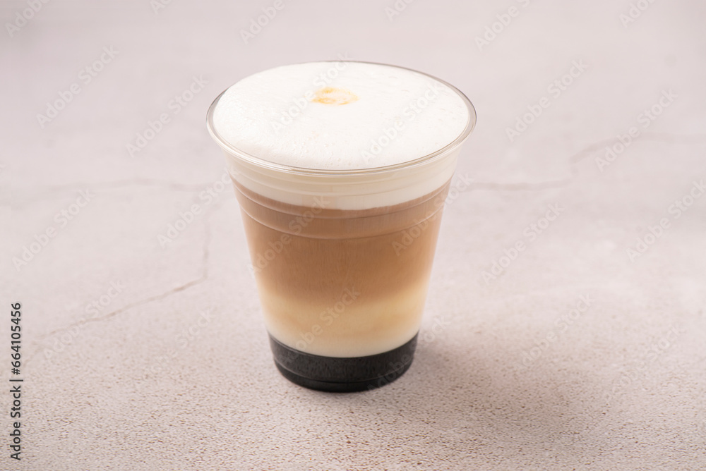 Ice latte. Coffee and Milk on to go package. Studio shoot on gray background. Ice latte. Coffee and Milk on to go package. Studio shoot on gray background.