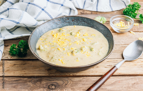 Traditional recipe of broccoli cheese soup with potato in a bowl