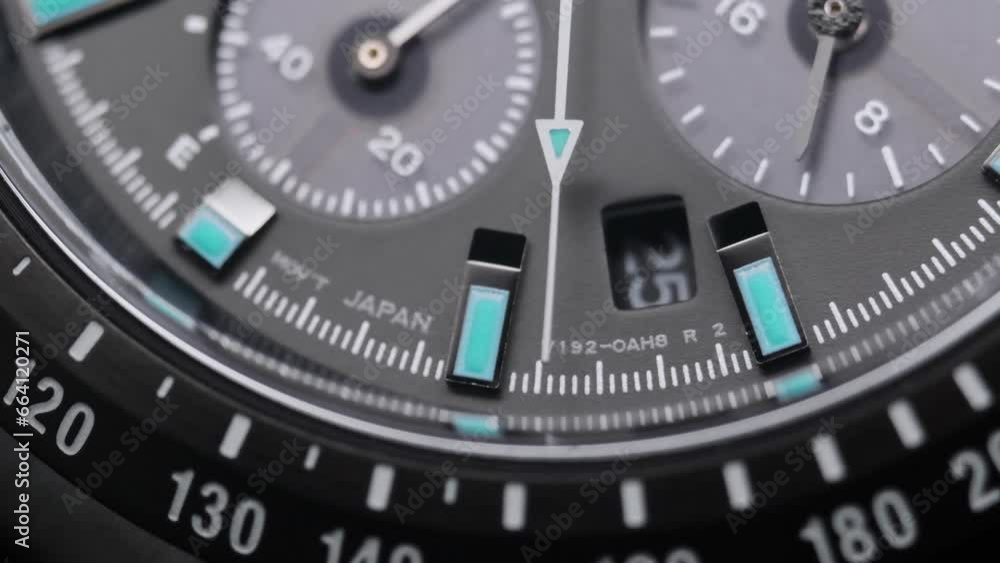 Second arrow running on the black clockface of luxury swiss watch with chronograph. Light flash on the turning clockface. Closeup real time shot. Running second arrow Second arrow running on the black clockface of luxury swiss watch with chronograph. Light flash on the turning clockface. Closeup real time shot. Running second arrow