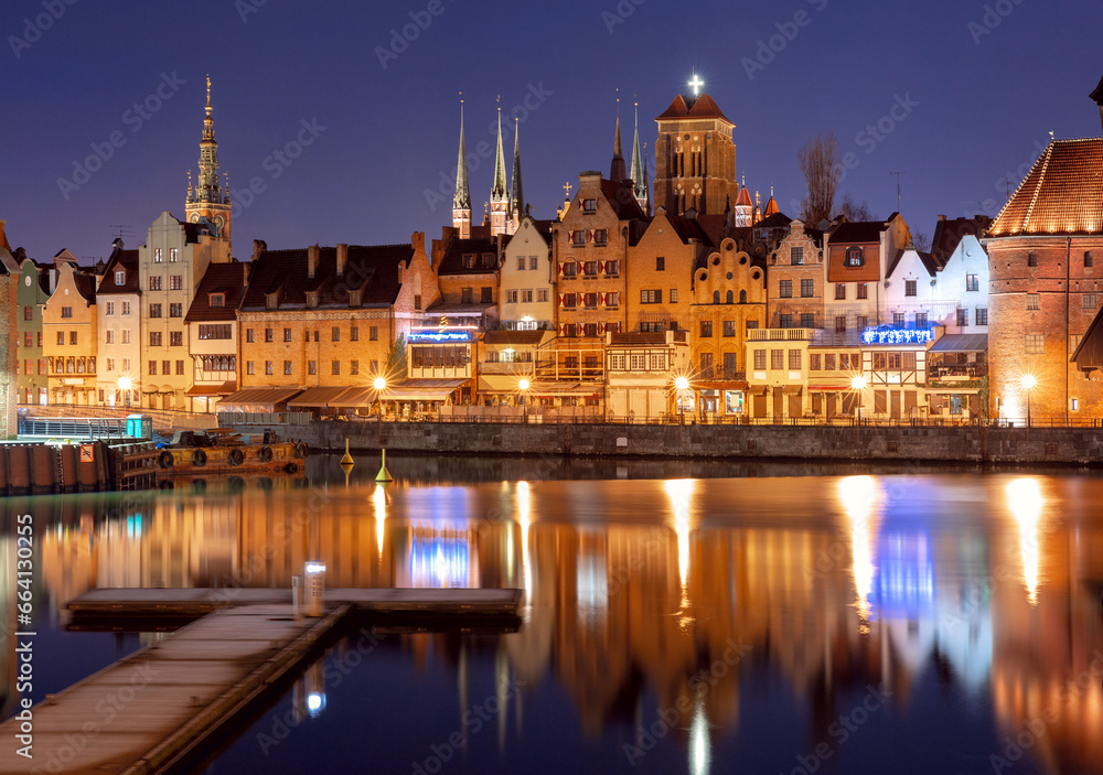 City embankment and facades of medieval houses in Old town at blue hour, Gdansk. Poland