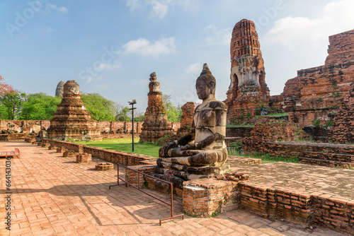 Buddha statue among ruins of the Wat Mahathat in Ayutthaya
