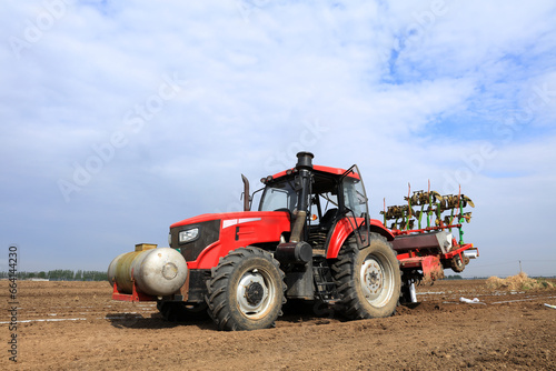 In spring  farmers use farm machinery to grow peanuts