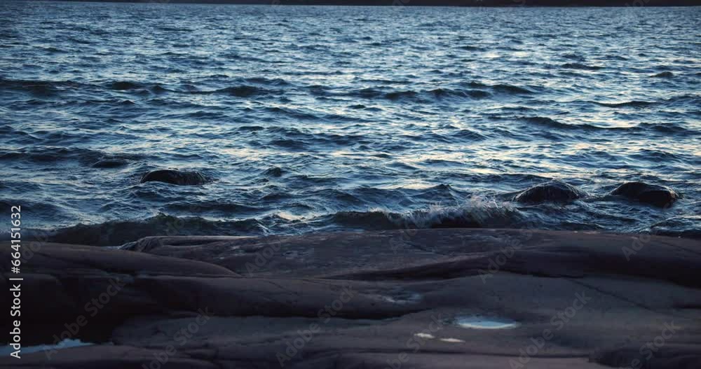 Waves crashing at the sandy sea shore at sundown. Waves crashing at the sandy sea shore at sundown.