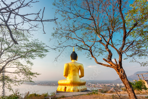 Large Golden Buddha statue at Wat Phousalao,overlooking Mekong River at sunset,Pakse,Laos. photo