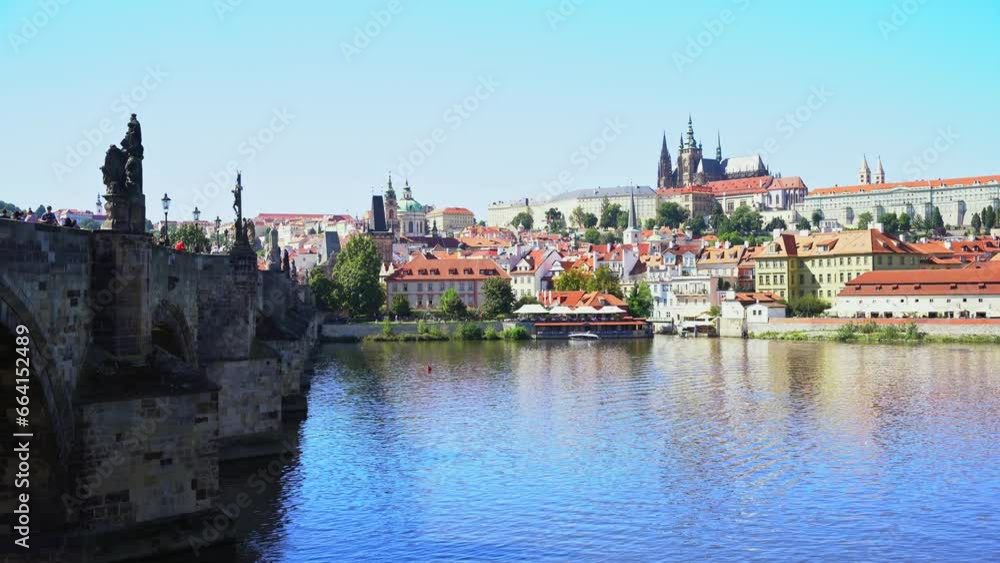 Charles Bridge towards the small town where you can see the Prague Castle in the Czech Republic, sunny day. Charles Bridge towards the small town where you can see the Prague Castle in the Czech Republic, sunny day.