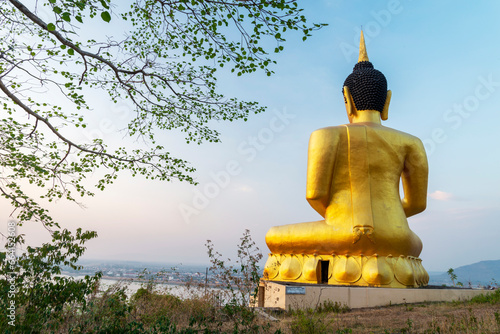 Large Golden Buddha statue at Wat Phousalao,overlooking Mekong River at sunset,Pakse,Laos. photo