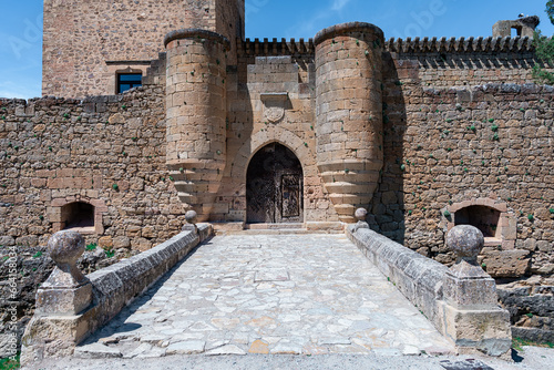 Castillo medieval típico europeo, ni siquiera le falta el nido de cigüeñas, un día soleado con cielo azul, desde Pedraza, Segovia, Castilla y León, España.