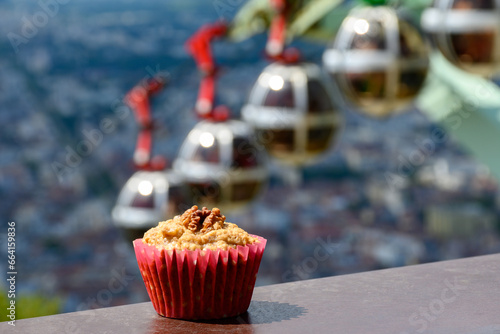 Gateau Grenoblois, French Walnut Coffee Cake, specialty from Grenoble and view on central part of Grenoble city from Bastille fortres witn mountains around, old cable car, Isere, France