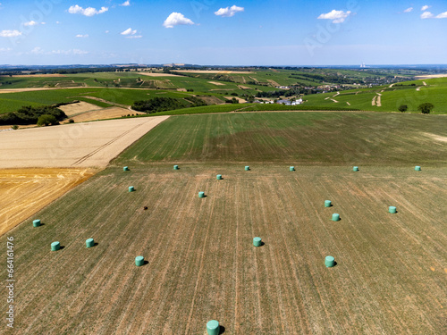 Fotografia Agriculture in France, yellow haystacks on golden wheat field in July, aerial vi