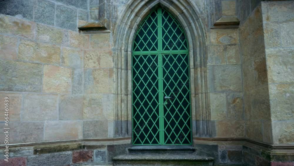 Large church door with green fittings. An approaching view with a mysterious and eerie atmosphere Large church door with green fittings. An approaching view with a mysterious and eerie atmosphere
