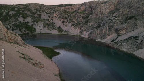 The rocky canyon walls which flank the Zrmanja River rush by as this drone shot approaches the water photo