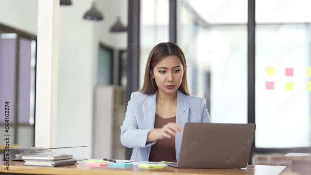 Serious young asian woman working on laptop business successful technology concept Serious young asian woman working on laptop business successful technology concept