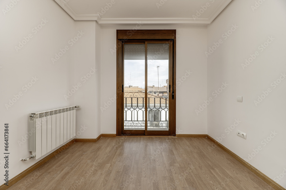 empty bedroom of a single-family home with access to a viewing balcony with aluminum door and brown glass empty bedroom of a single-family home with access to a viewing balcony with aluminum door and brown glass