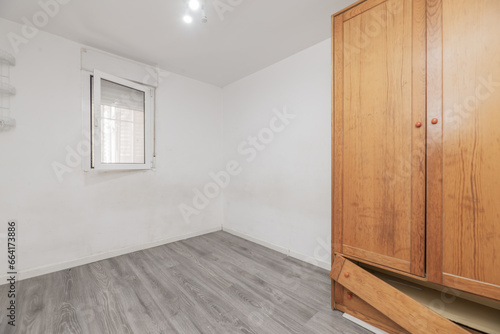 Εκτύπωση καμβά Empty room with a rickety wooden cabinet with drawers and an open aluminum windo