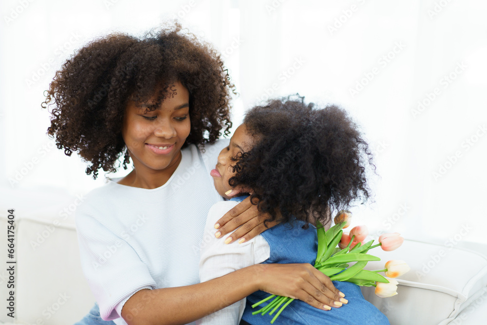 Lovely cute little girl gives mother her drawing post card in the international Mother's Day, American - African black ethnic family portrait. International Mother's Day concept. Lovely cute little girl gives mother her drawing post card in the international Mother's Day, American - African black ethnic family portrait. International Mother's Day concept.
