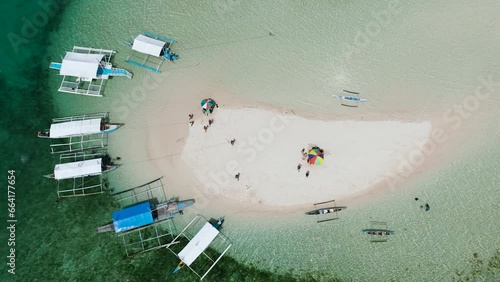 Drone view of boats on coastline of sandbar, turquoise water and colar reefs. Barobo, Surigao del Sur. Philippines. photo