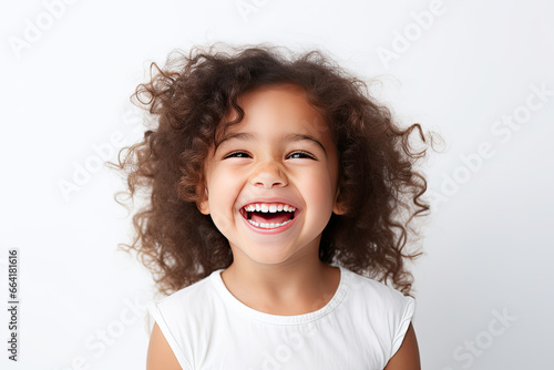 cute child model with perfect clean teeth laughing and smiling. isolated on white background