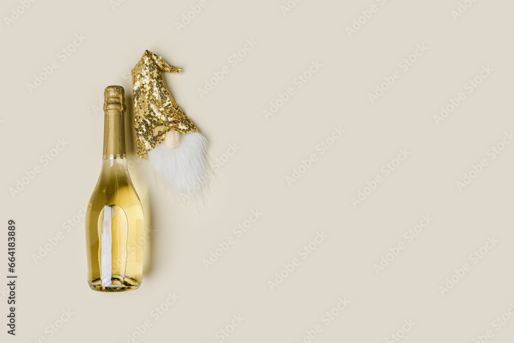 Champagne bottle and decor for bottle of wine, golden sequins hat of dwarf, Christmas and New Year holidays, festive background, copy space. Minimal style trend, beige golden colors - obrazy, fototapety, plakaty 