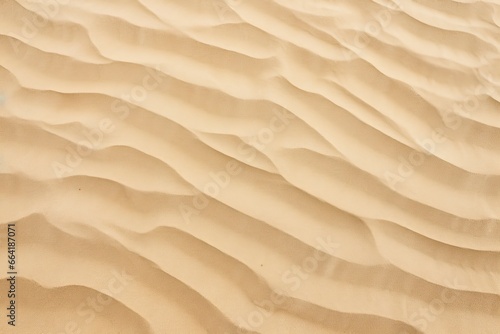 Closeup of sand pattern of a beach in the summer. © Anny
