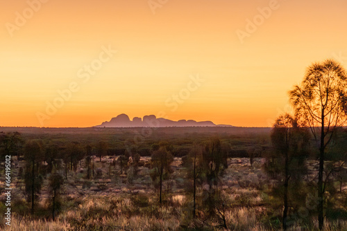 Sunset over australian outback in Northern Territory Australia, with Mount Olgas at background. photo