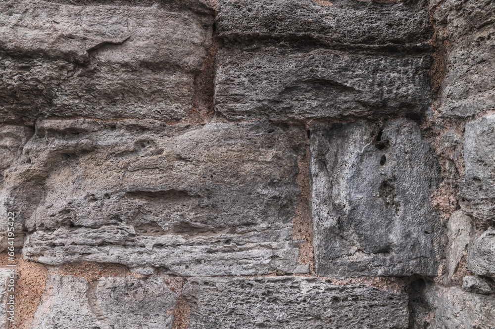Texture of the surface of an ancient stone wall. Texture of the surface of an ancient stone wall.