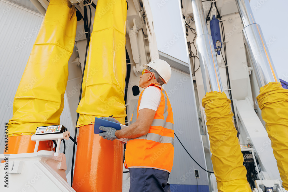 Hydraulic engineer doing safety check on new installation hoses