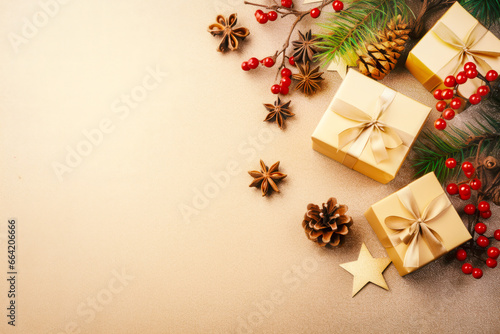 Christmas decoration composition on beige background with gift box , fir branches, pine cones, starfish, red berries,  top view, copy space, banner format © yin foo Tan