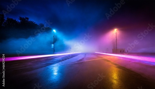 Dark background of empty foggy wet asphalt in the night illuminated by a searhlight