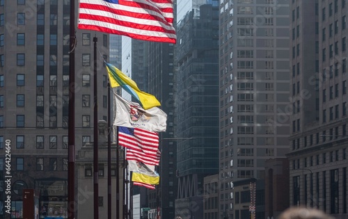 High resolution image of American flags together with the flag of the city of Chicago and Illinois in the background Chicago's famous magnificent mile