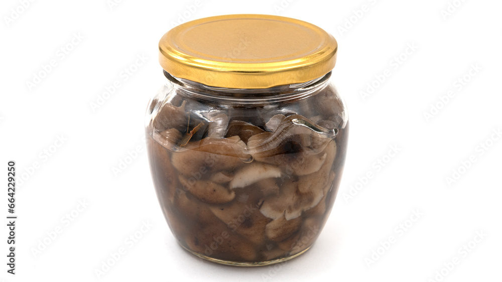 Pickled mushrooms in a glass jar isolated on white background Pickled mushrooms in a glass jar isolated on white background