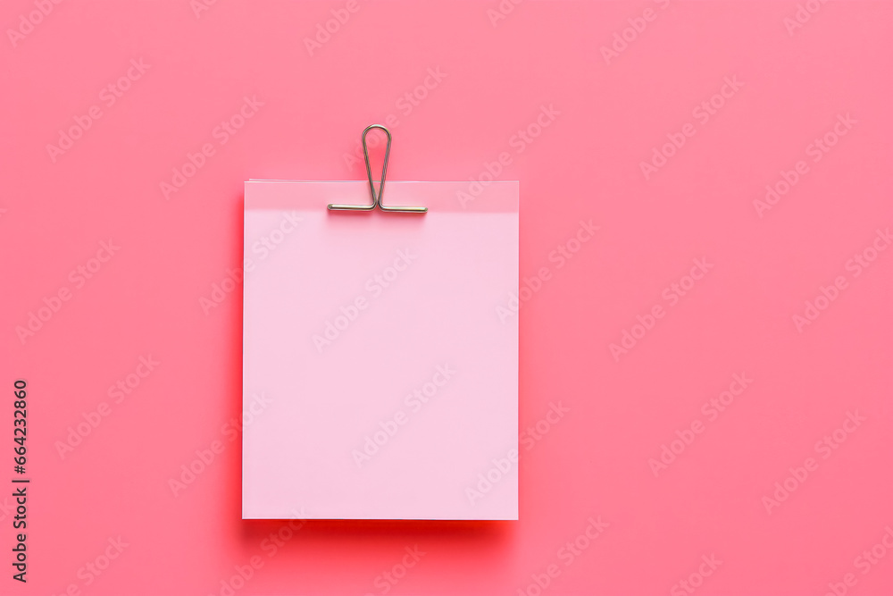 Pink sticky post it note with paper clip on pink background. Mock up of pink note. Pink sticky post it note with paper clip on pink background. Mock up of pink note.