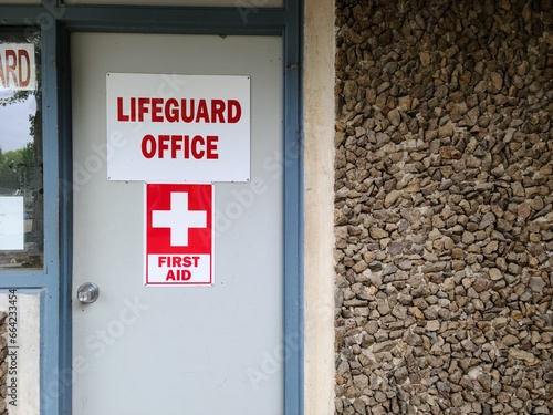 Lifeguard office sign on the entrance of the building near beach