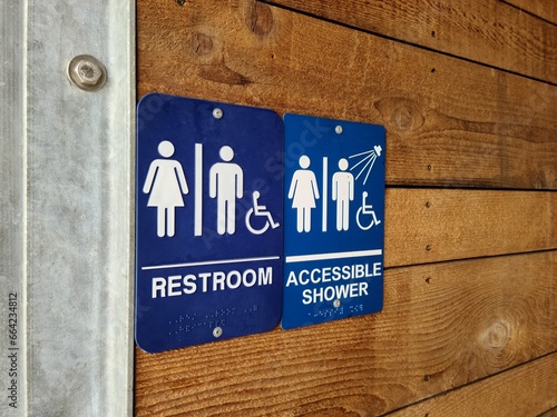 Restroom signs for men, women and handicapped in an outdoor facility